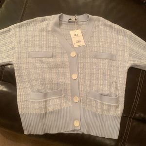 Very pretty cardigan sweater.  Light blue & white. New with tags.  NWT.  Medium.